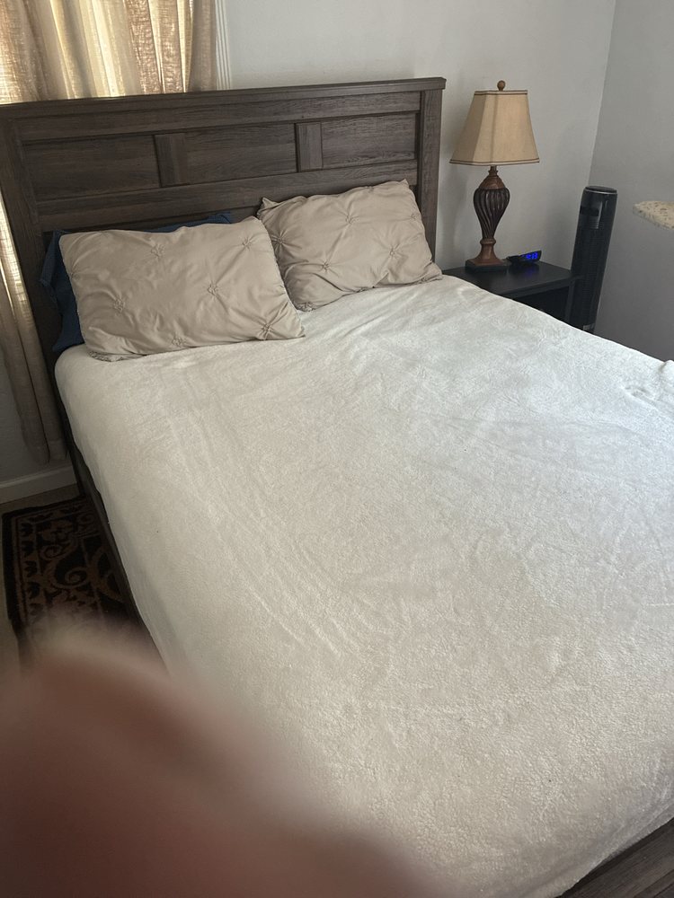 Neatly made bedroom after house cleaning